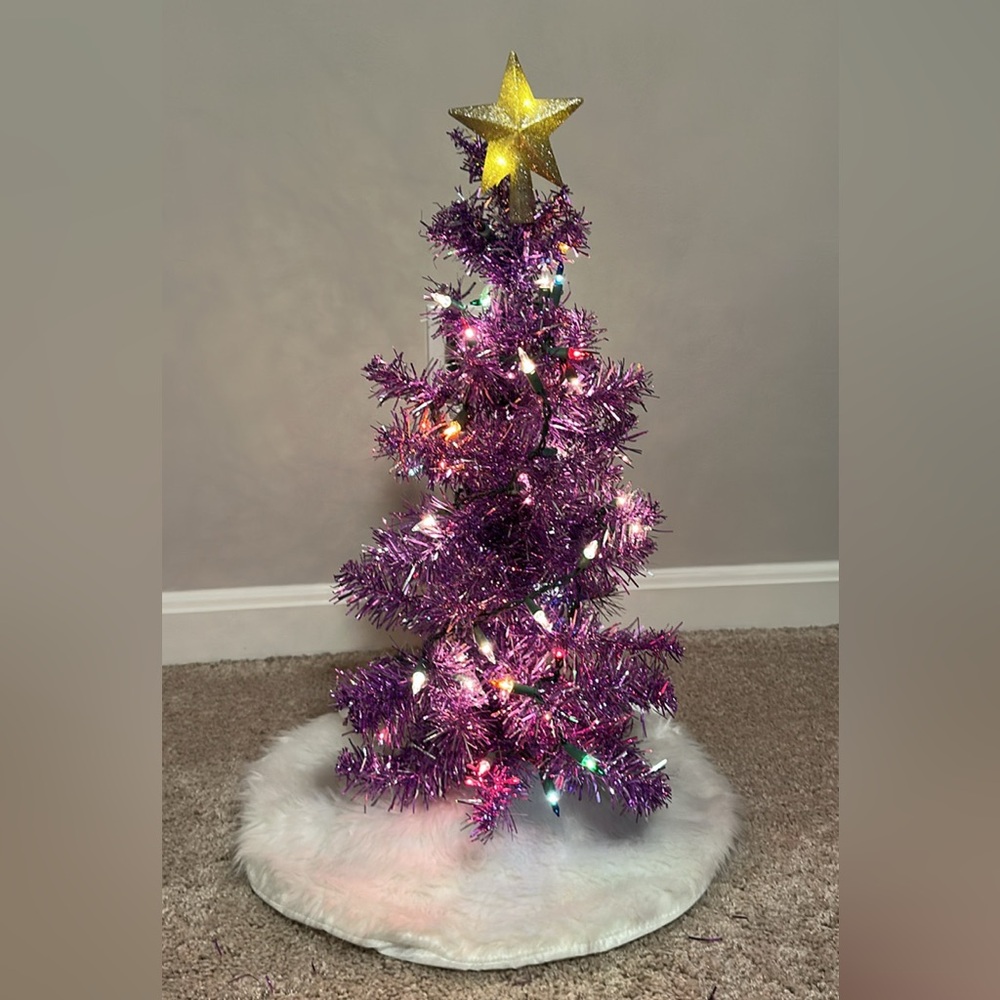 Purple metallic miniature Christmas tree with lights and white fur tree skirt
